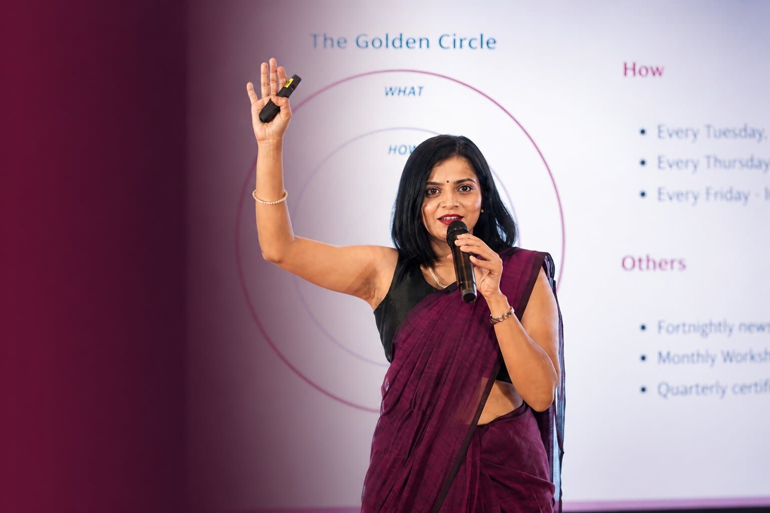 SHELeadsIndia founder presenting on stage