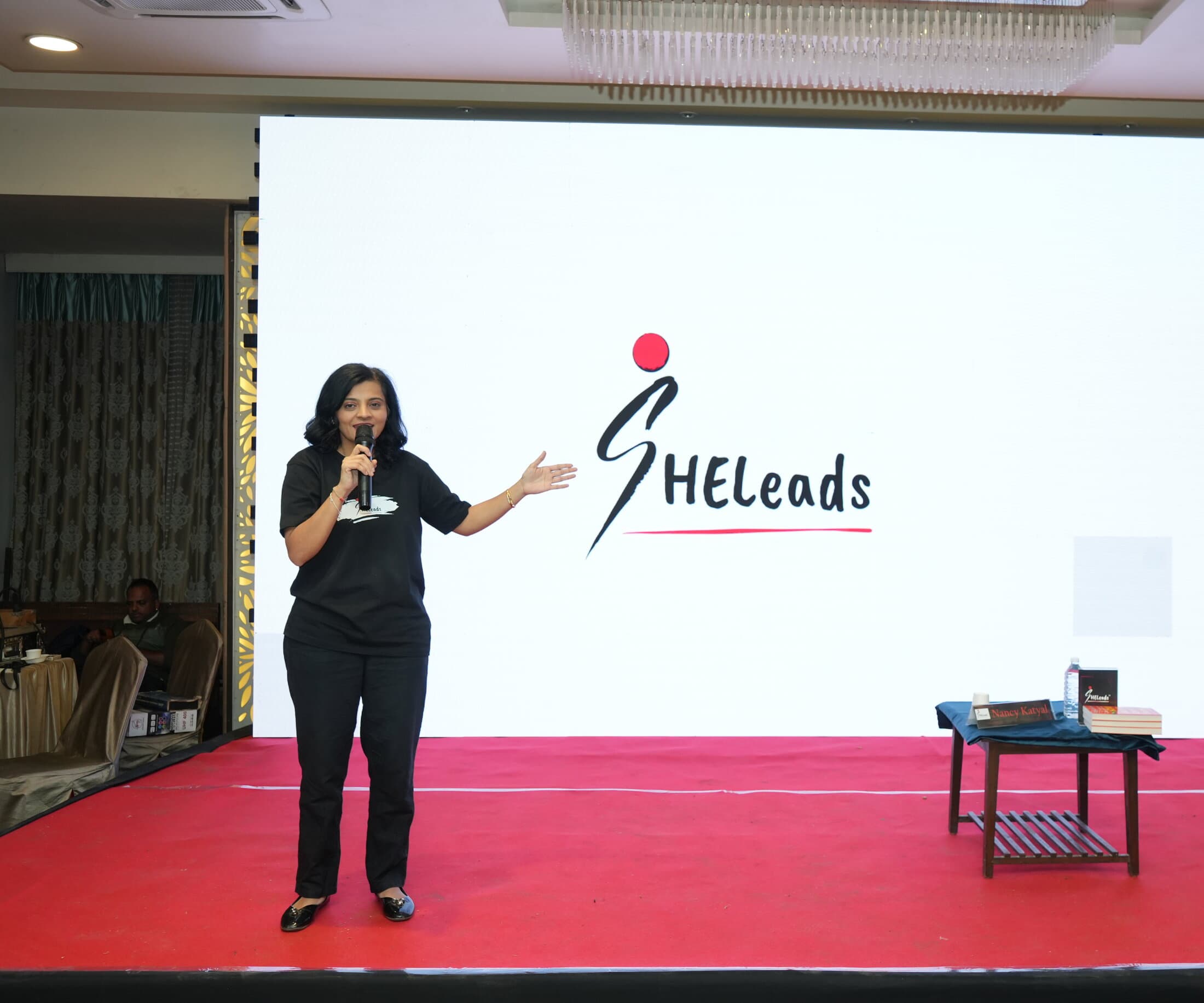 Nikita Vora addressing the SHELeadsIndia community on stage